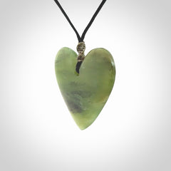 A hand carved heart pendant made from New Zealand jade.