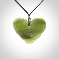 A hand carved heart pendant made from New Zealand jade.