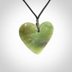 A hand carved heart pendant made from New Zealand jade.