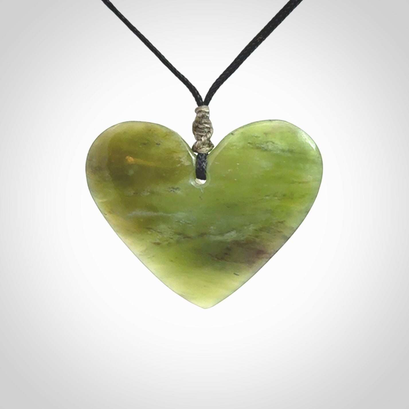 A hand carved heart pendant made from New Zealand jade.