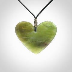 A hand carved heart pendant made from New Zealand jade.