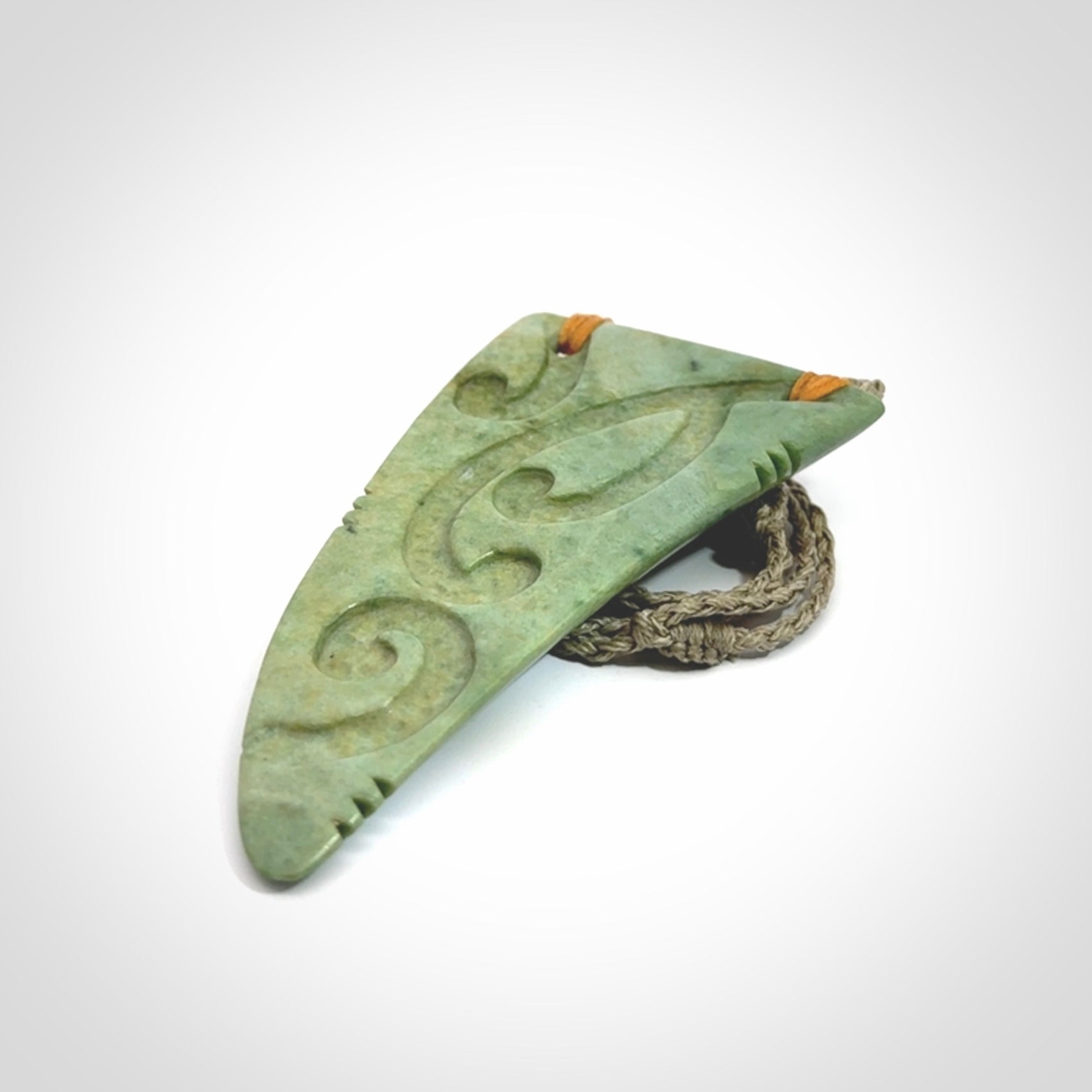 Hand carved New Zealand Flower jade Rei Puta pendant with four Koru engraving.