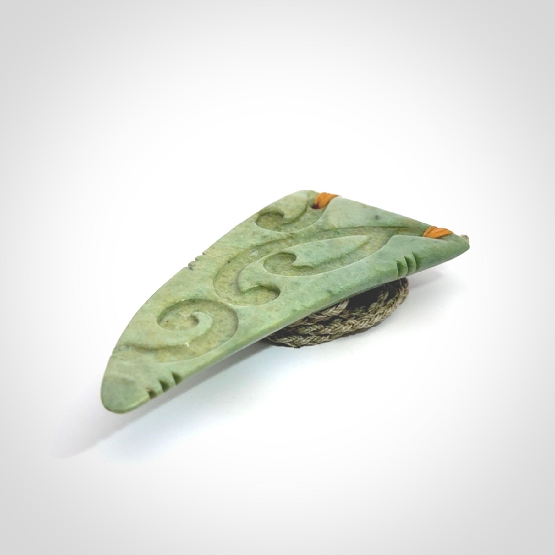 Hand carved New Zealand Flower jade Rei Puta pendant with four Koru engraving.