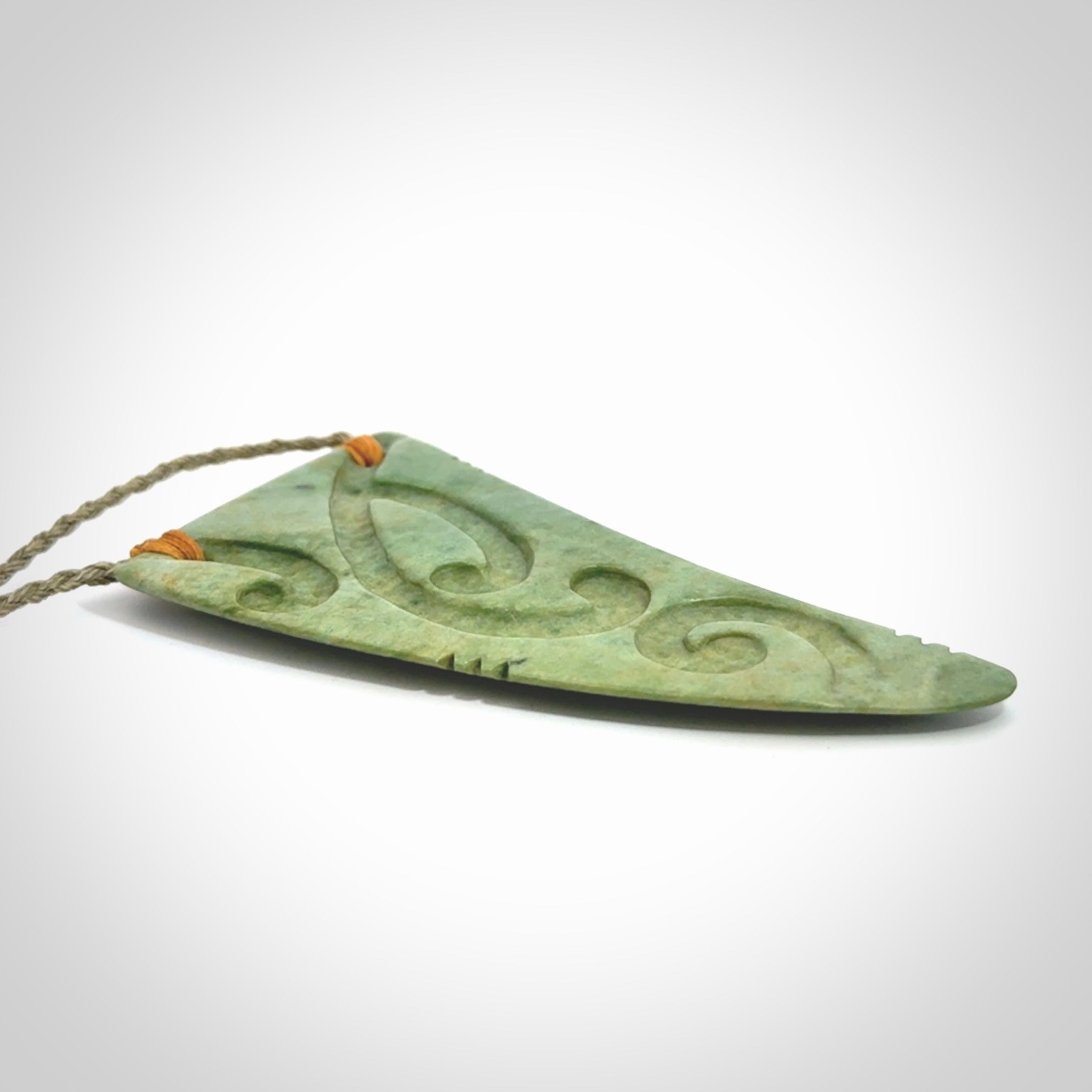 Hand carved New Zealand Flower jade Rei Puta pendant with four Koru engraving.