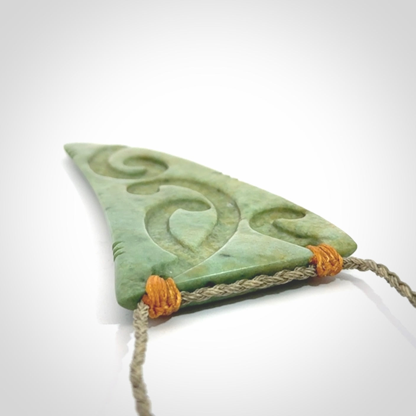 Hand carved New Zealand Flower jade Rei Puta pendant with four Koru engraving.