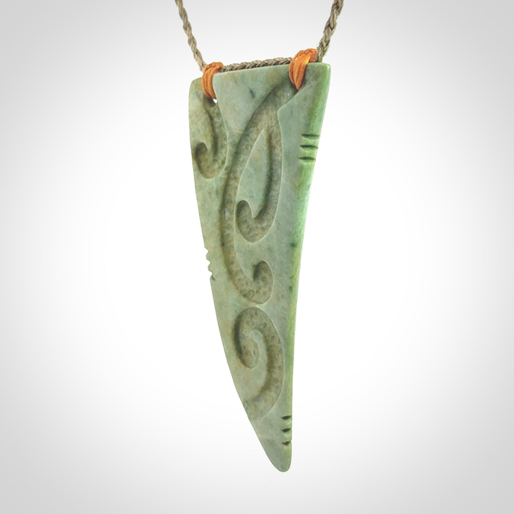 Hand carved New Zealand Flower jade Rei Puta pendant with four Koru engraving.