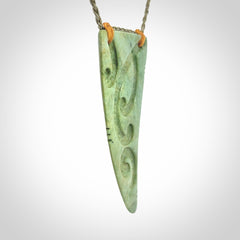 Hand carved New Zealand Flower jade Rei Puta pendant with four Koru engraving.