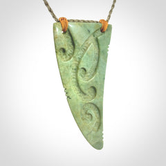 Hand carved New Zealand Flower jade Rei Puta pendant with four Koru engraving.