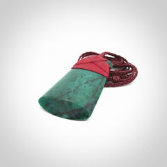 This is a handcrafted aotea stone Toki pendant.