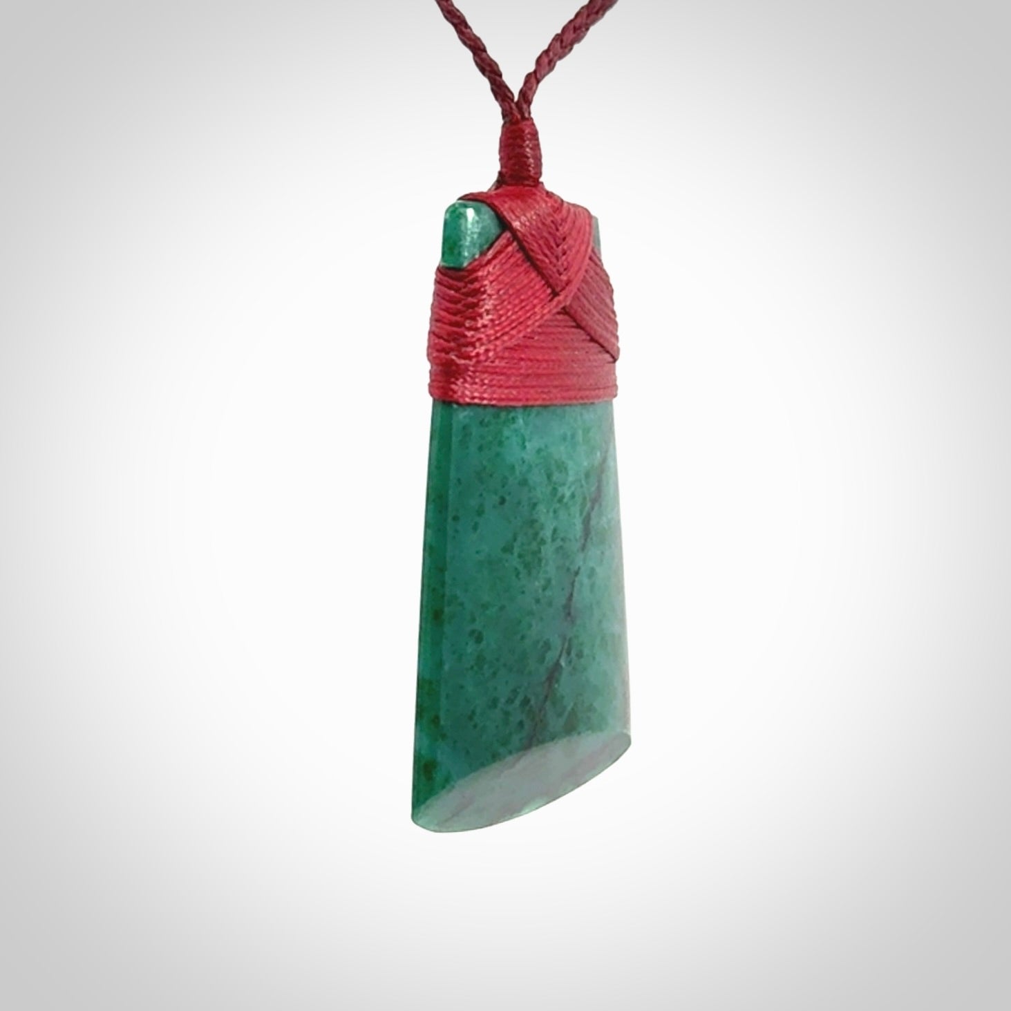 This is a handcrafted aotea stone Toki pendant.
