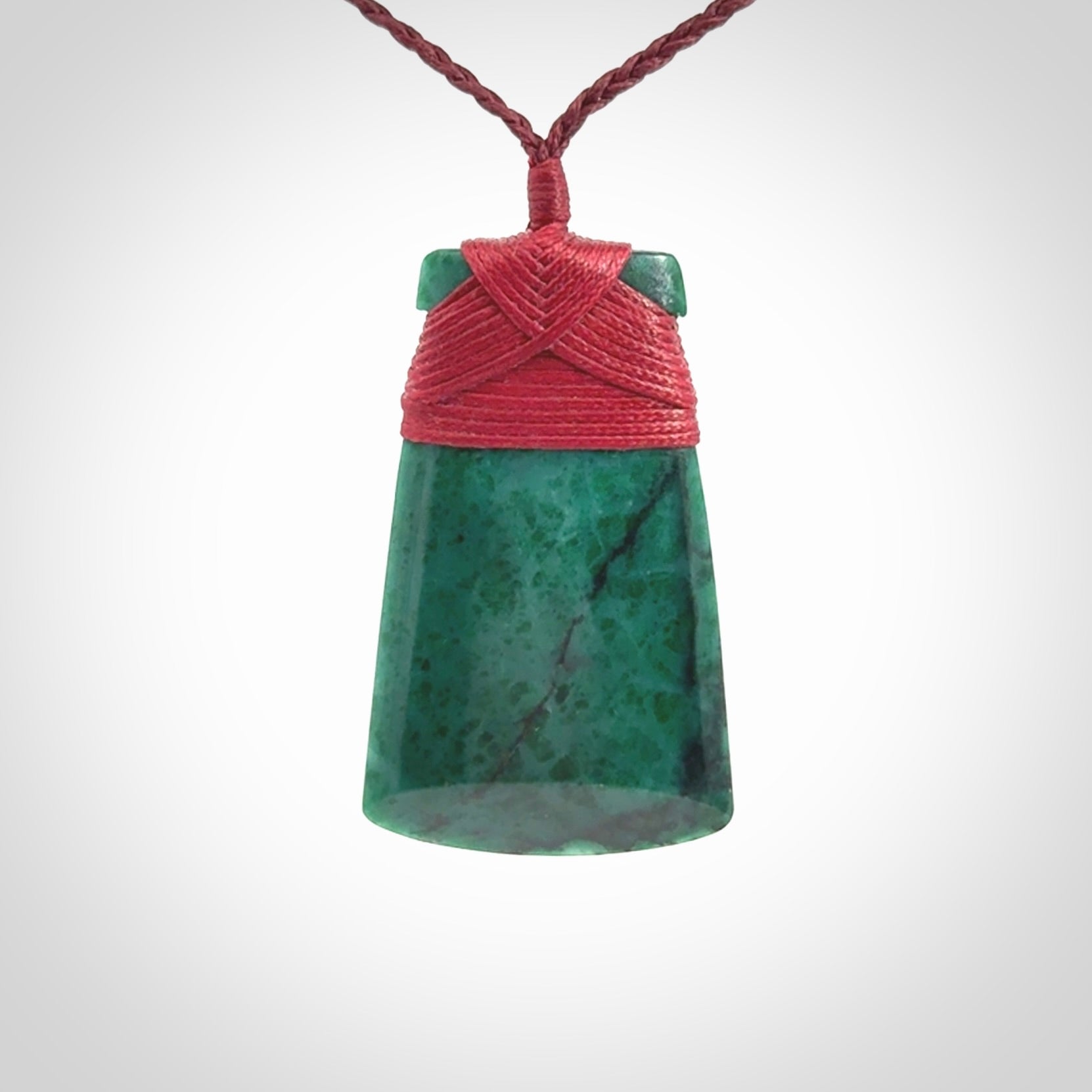 This is a handcrafted aotea stone Toki pendant.