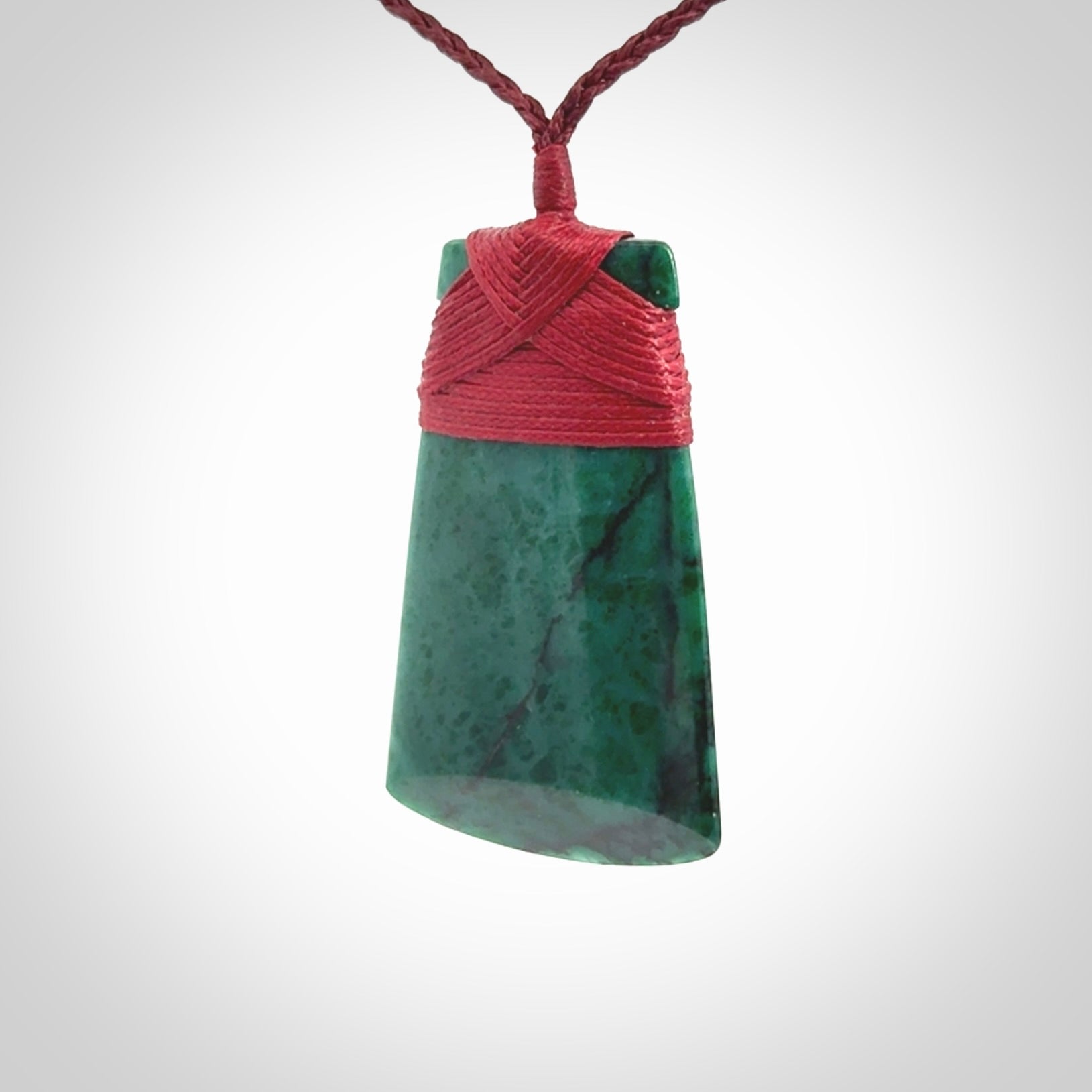 This is a handcrafted aotea stone Toki pendant.