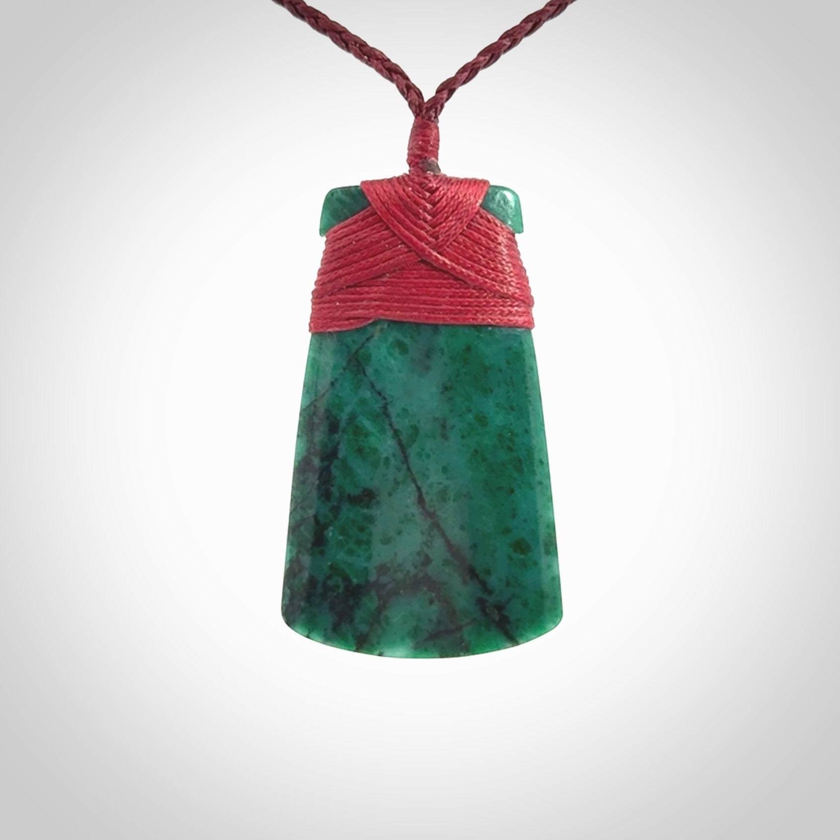 This is a handcrafted aotea stone Toki pendant.