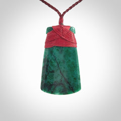 This is a handcrafted aotea stone Toki pendant.
