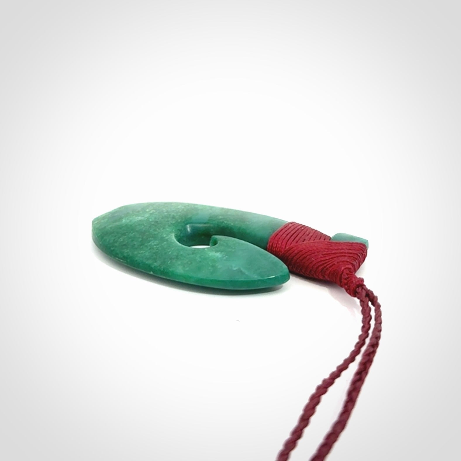 This is a handcrafted aotea stone Hook pendant.