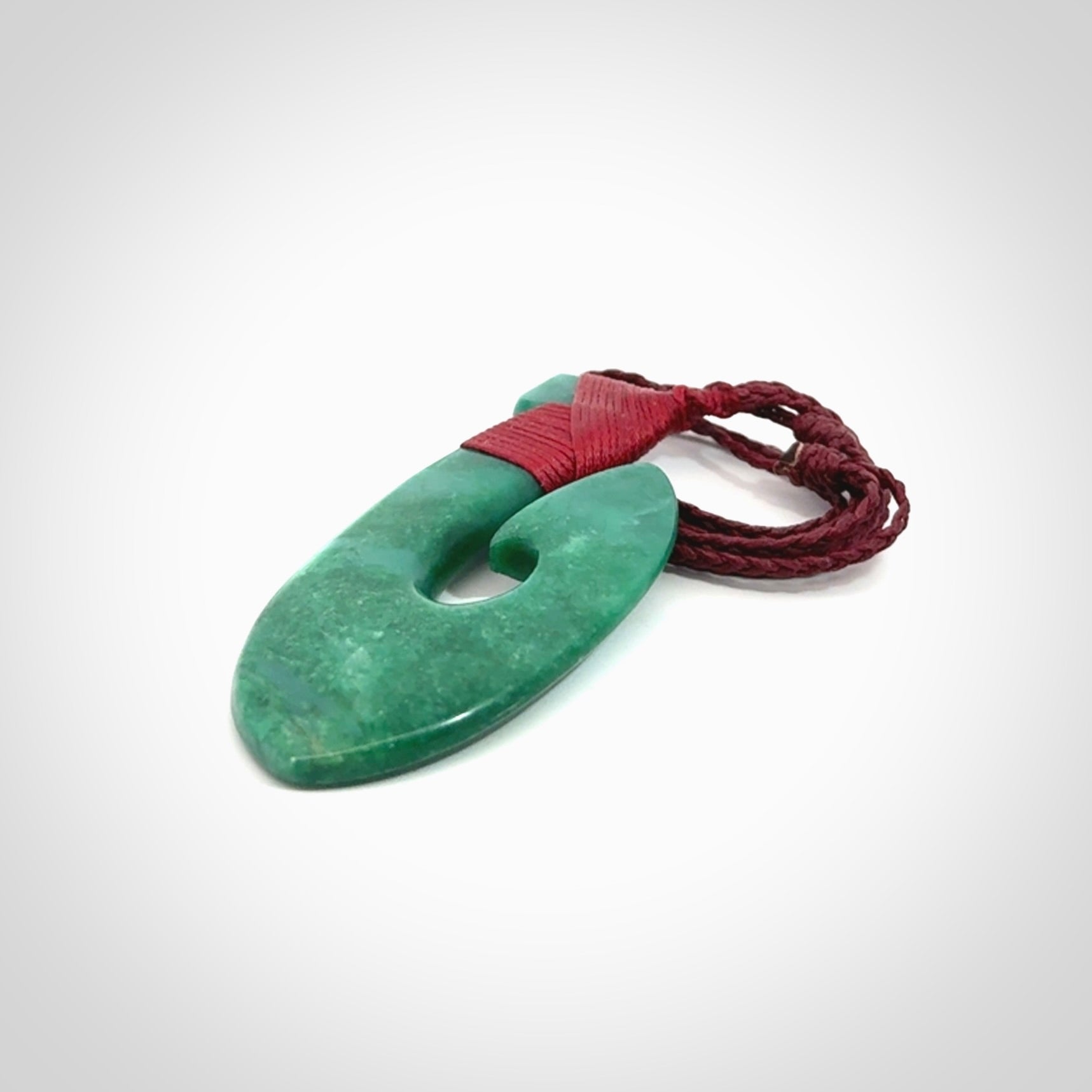 This is a handcrafted aotea stone Hook pendant.