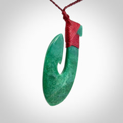 This is a handcrafted aotea stone Hook pendant.