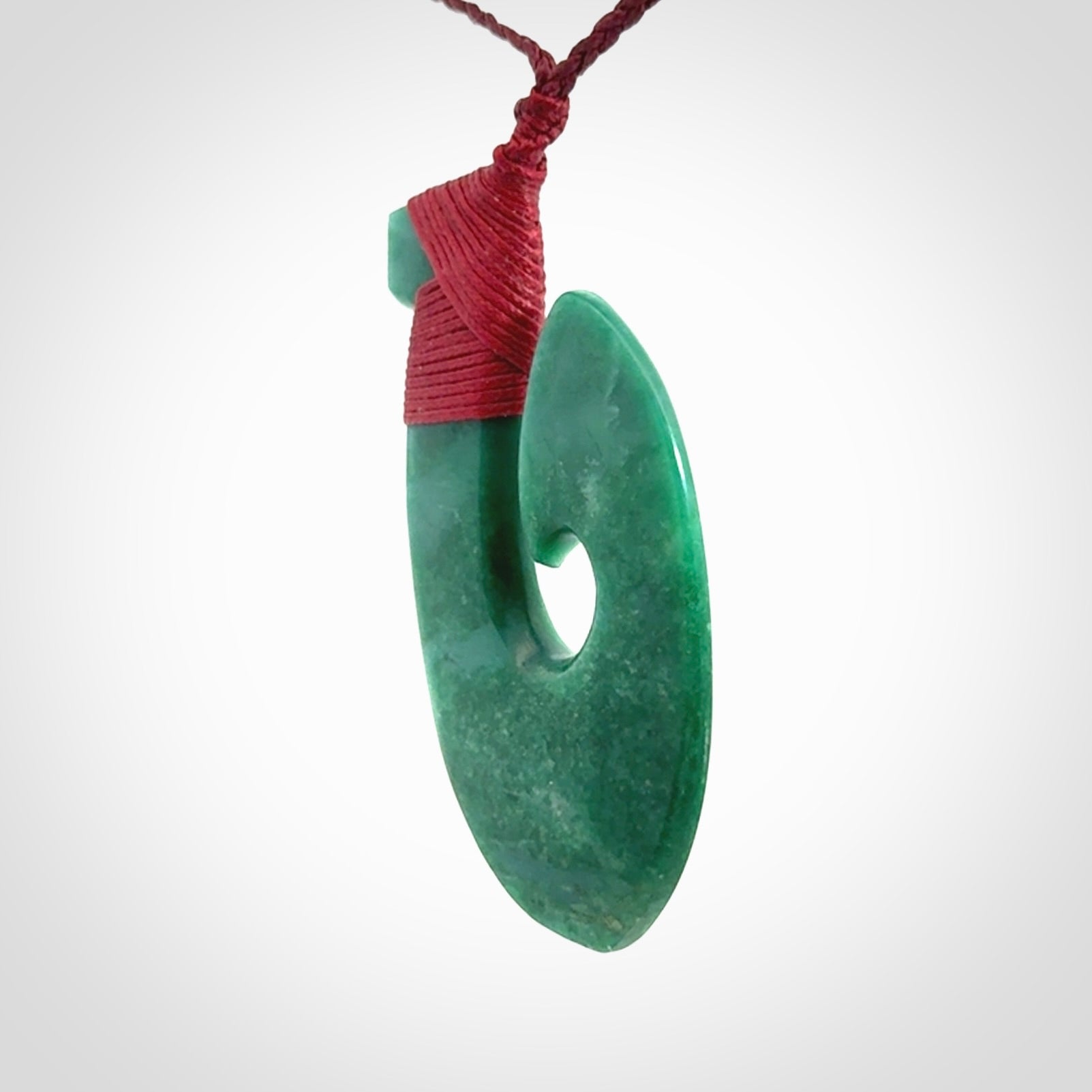 This is a handcrafted aotea stone Hook pendant.