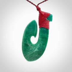 This is a handcrafted aotea stone Hook pendant.