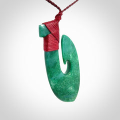 This is a handcrafted aotea stone Hook pendant.