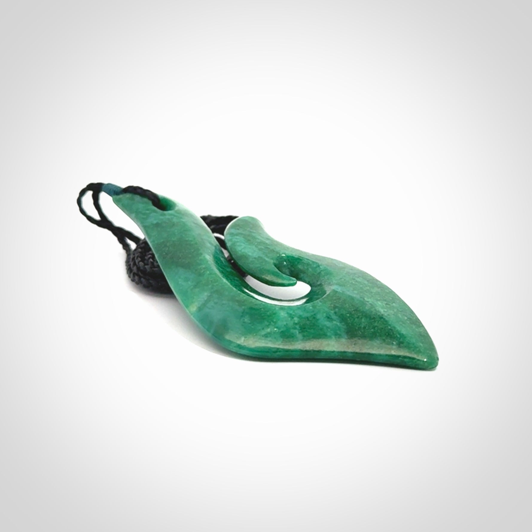This is a handcrafted aotea stone Hook pendant.
