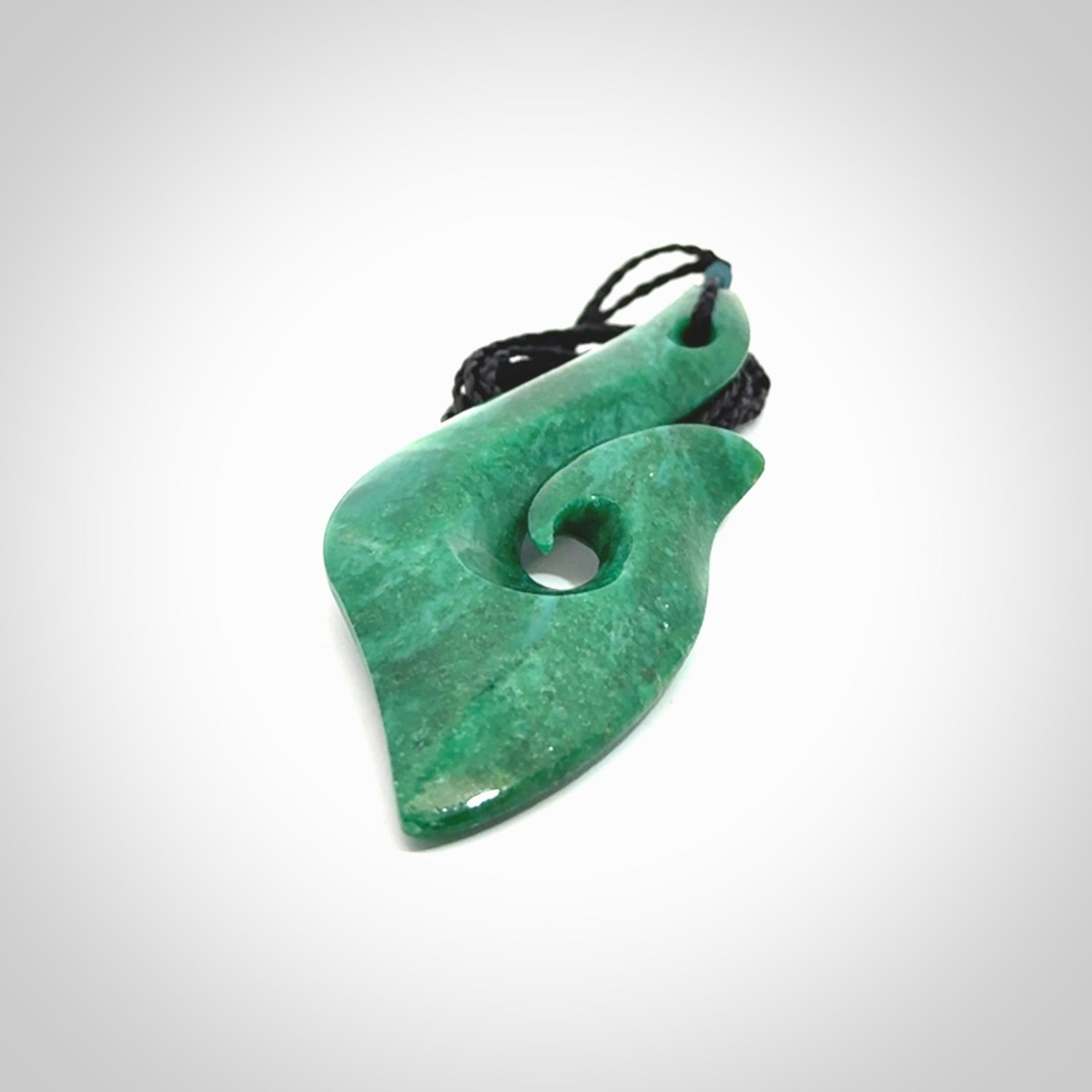 This is a handcrafted aotea stone Hook pendant.
