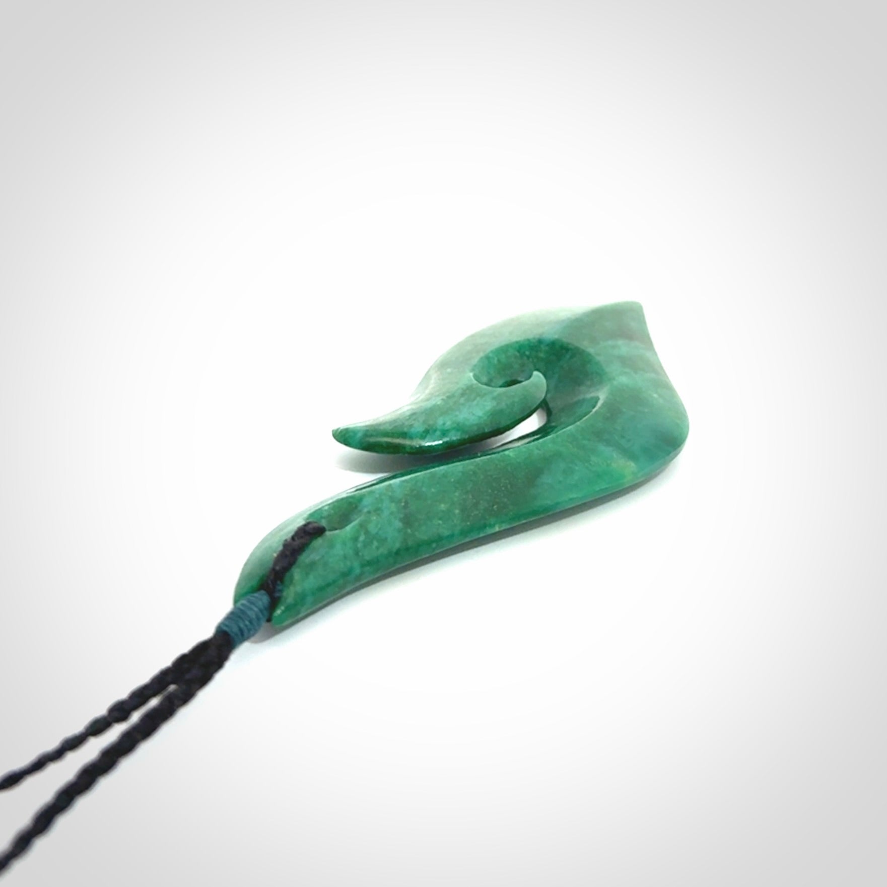 This is a handcrafted aotea stone Hook pendant.