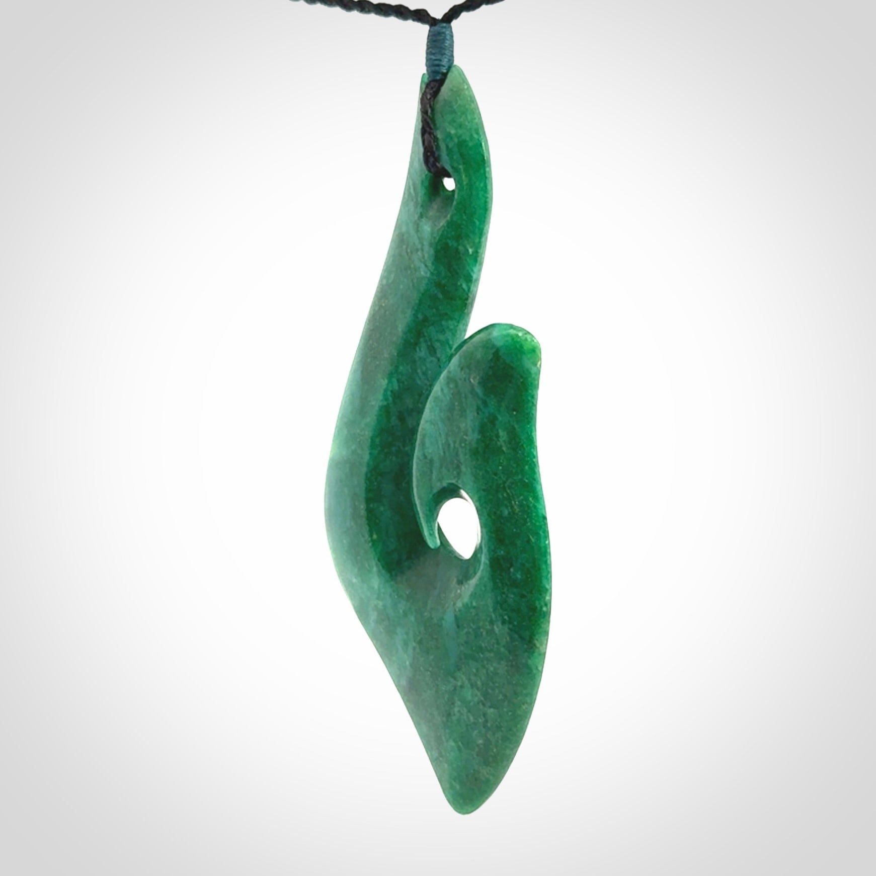 This is a handcrafted aotea stone Hook pendant.