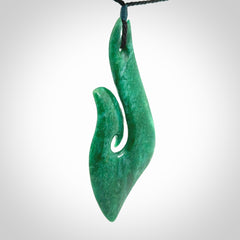 This is a handcrafted aotea stone Hook pendant.