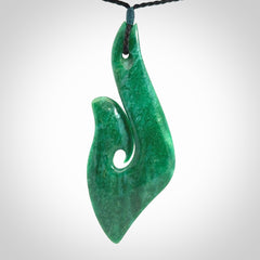 This is a handcrafted aotea stone Hook pendant.