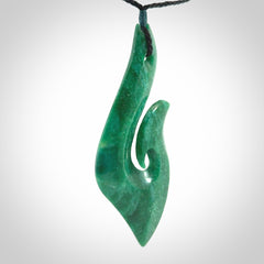 This is a handcrafted aotea stone Hook pendant.