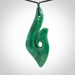This is a handcrafted aotea stone Hook pendant.