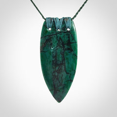 This is a handcrafted aotea stone rei puta pendant.