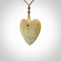 A hand carved heart pendant made from New Zealand Flower jade.