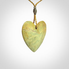 A hand carved heart pendant made from New Zealand Flower jade.