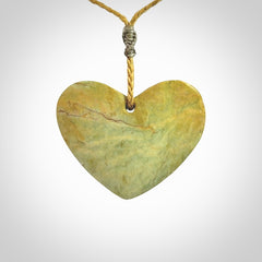 A hand carved heart pendant made from New Zealand Flower jade.