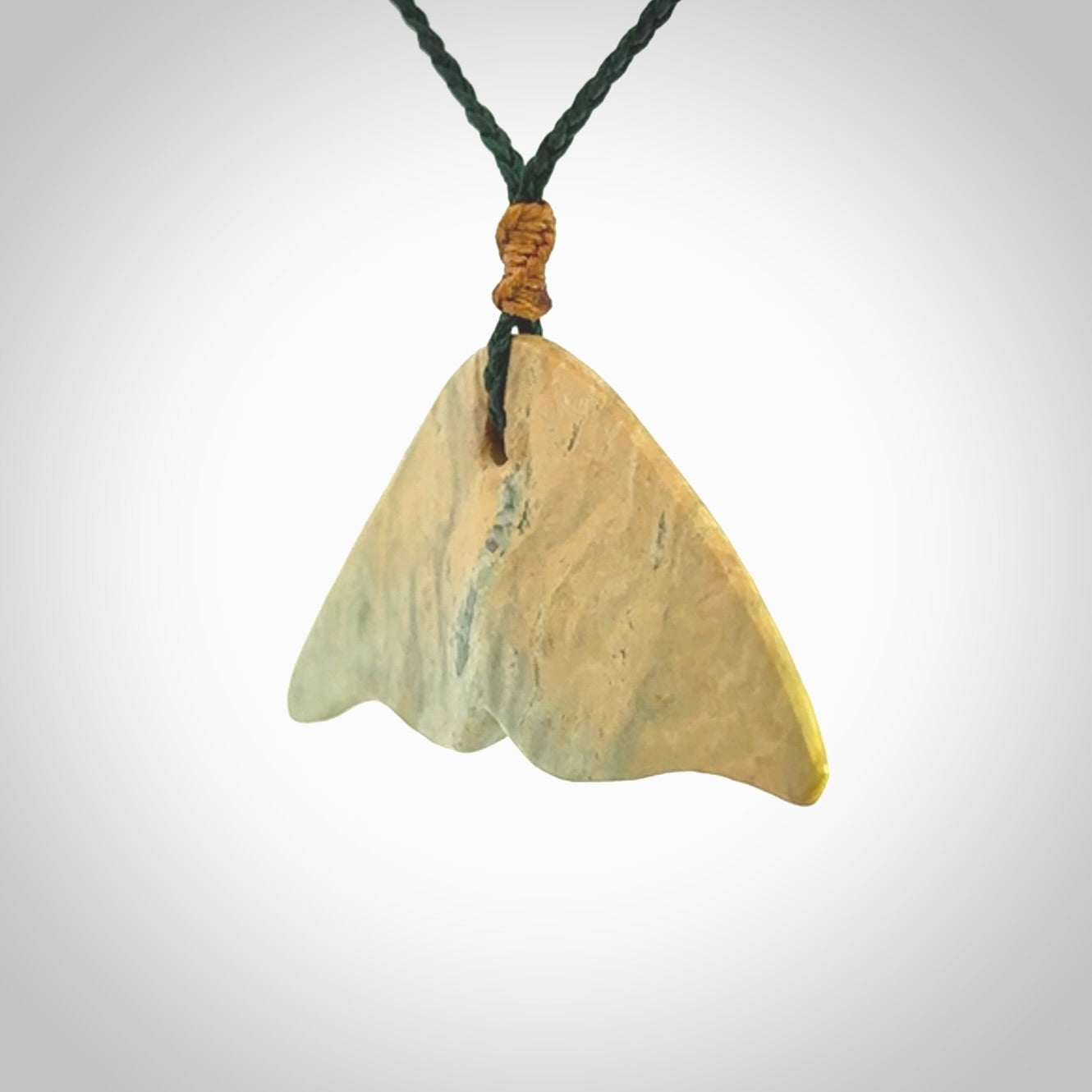 Hand carved New Zealand Jade whale tail pendant.