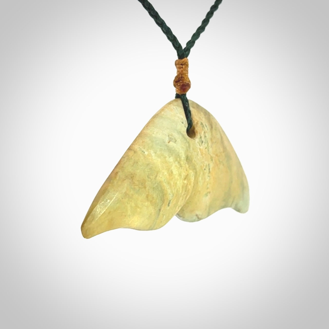Hand carved New Zealand Jade whale tail pendant.