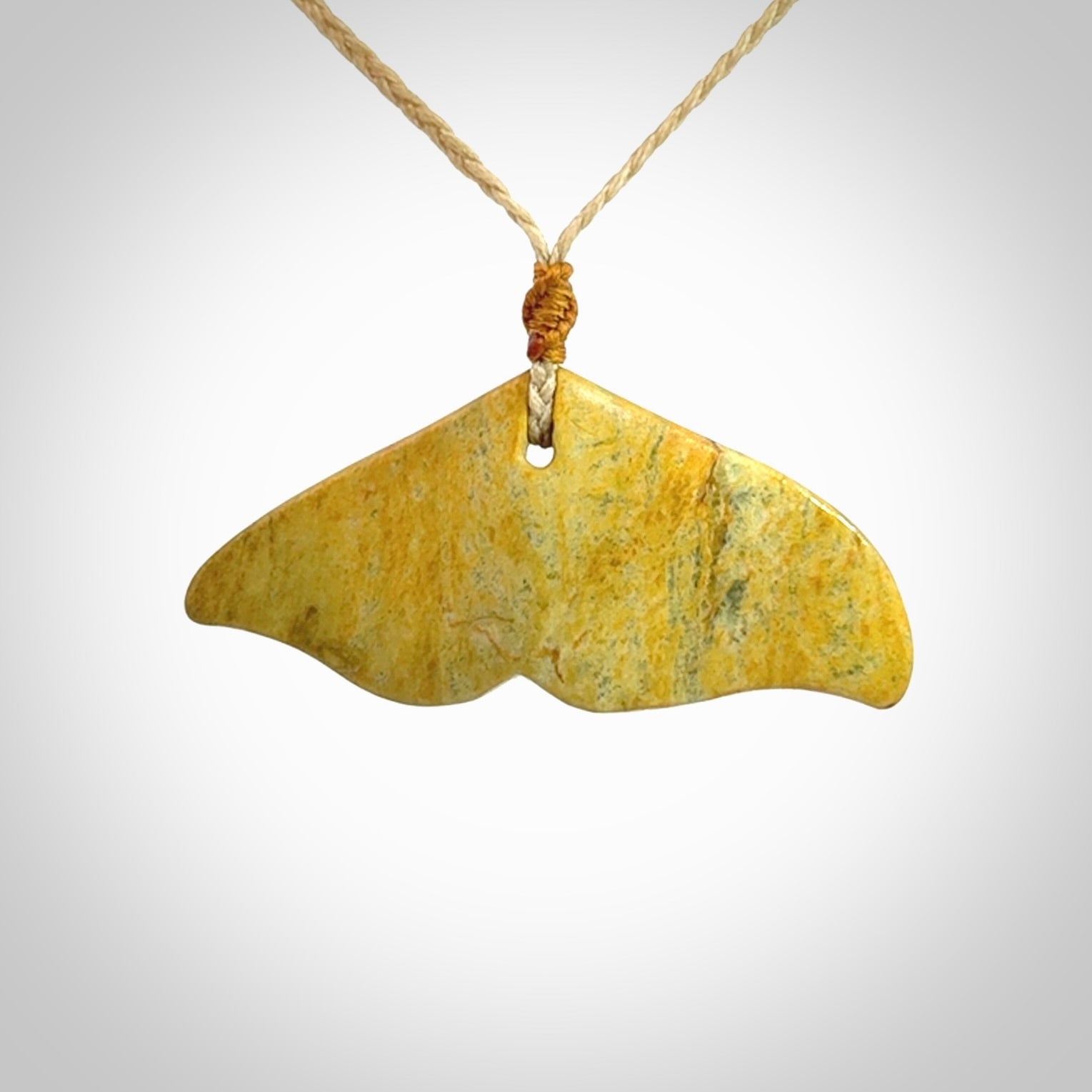 Hand carved New Zealand Flower Jade whale tail pendant.