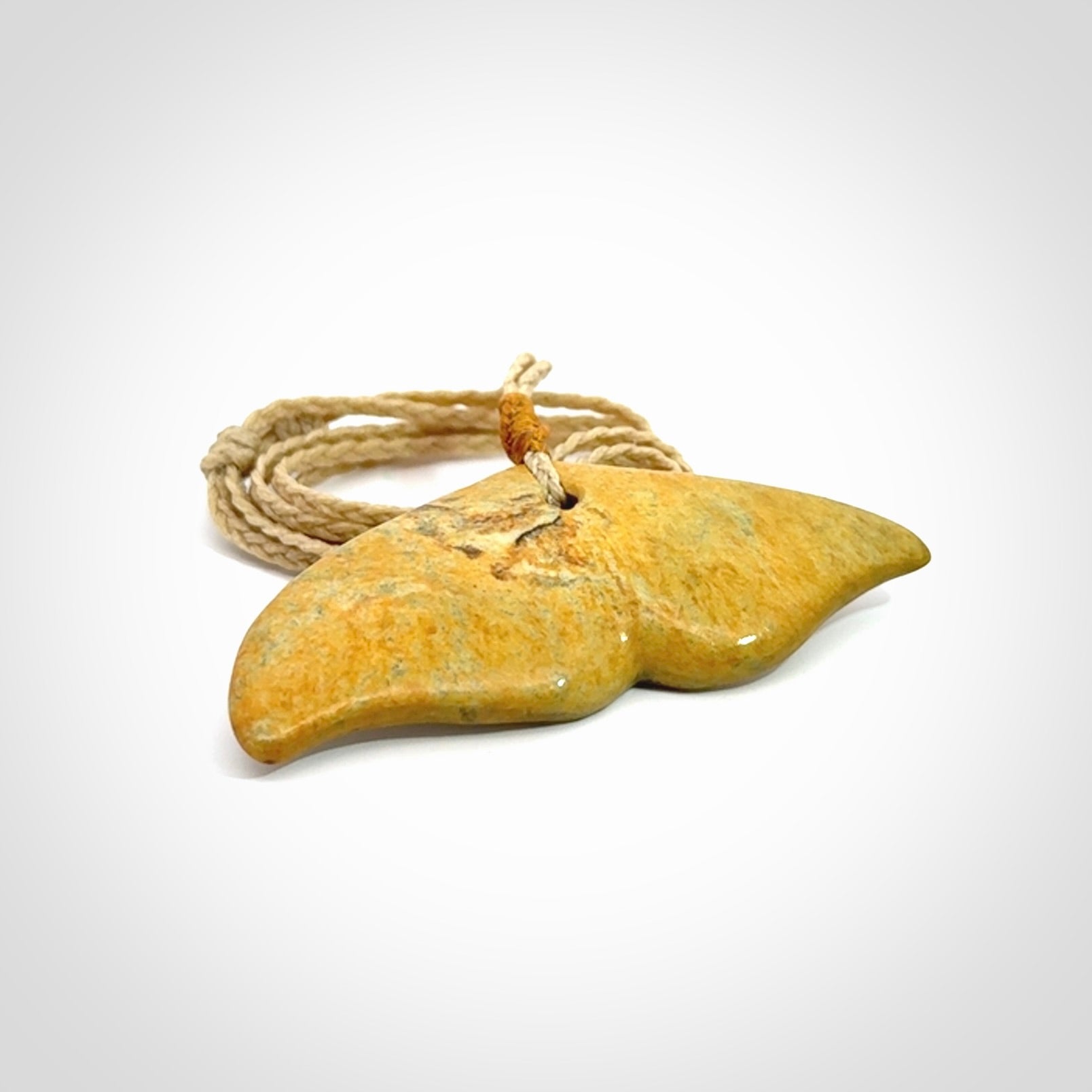 Hand carved New Zealand Flower Jade whale tail pendant.