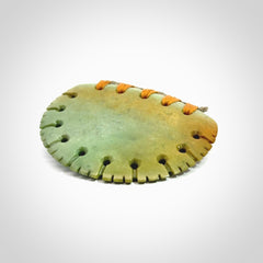 Hand carved New Zealand Flower Jade half-shield pendant.