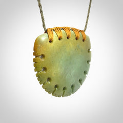 Hand carved New Zealand Flower Jade half-shield pendant.