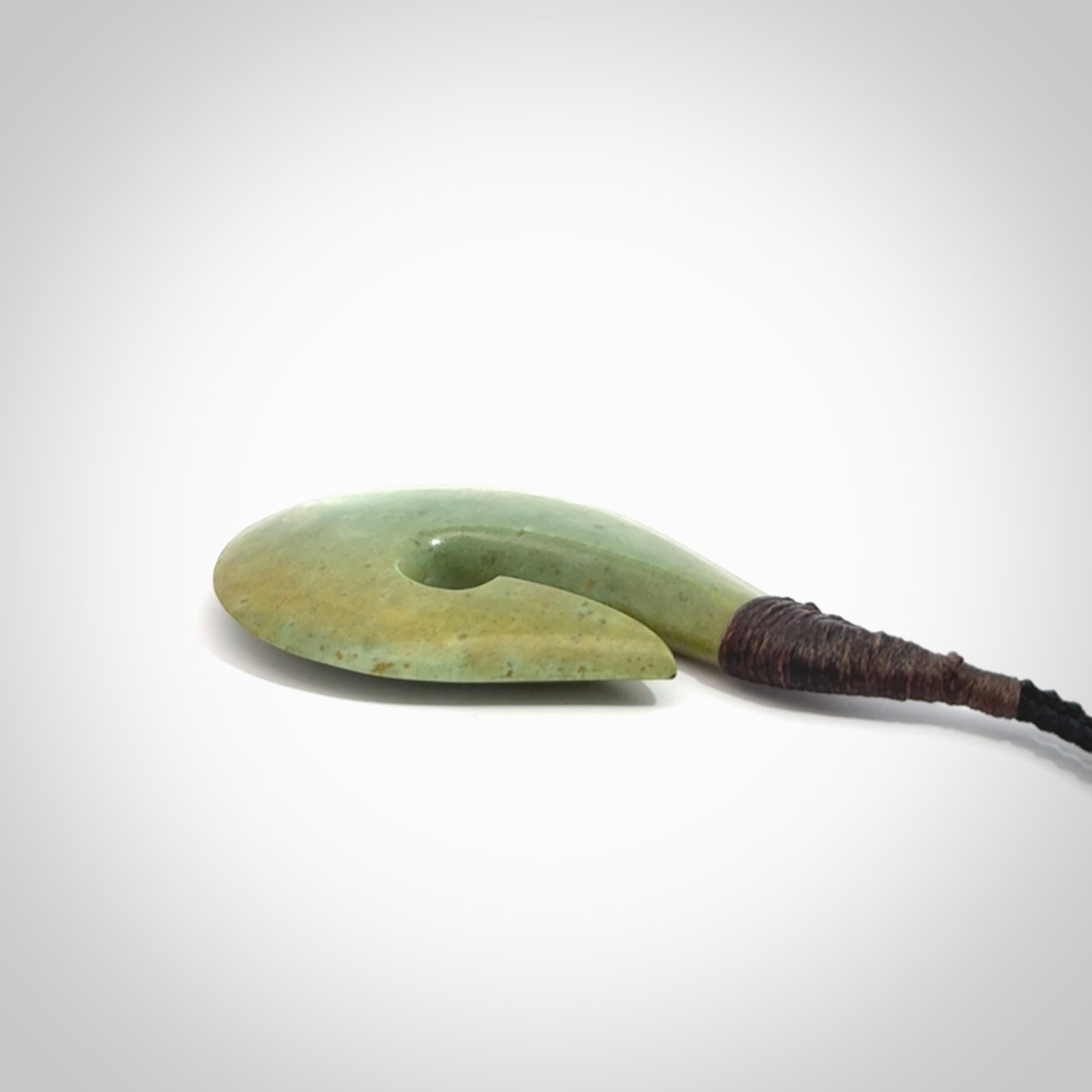 Hand carved New Zealand flower jade hook, matau pendant.