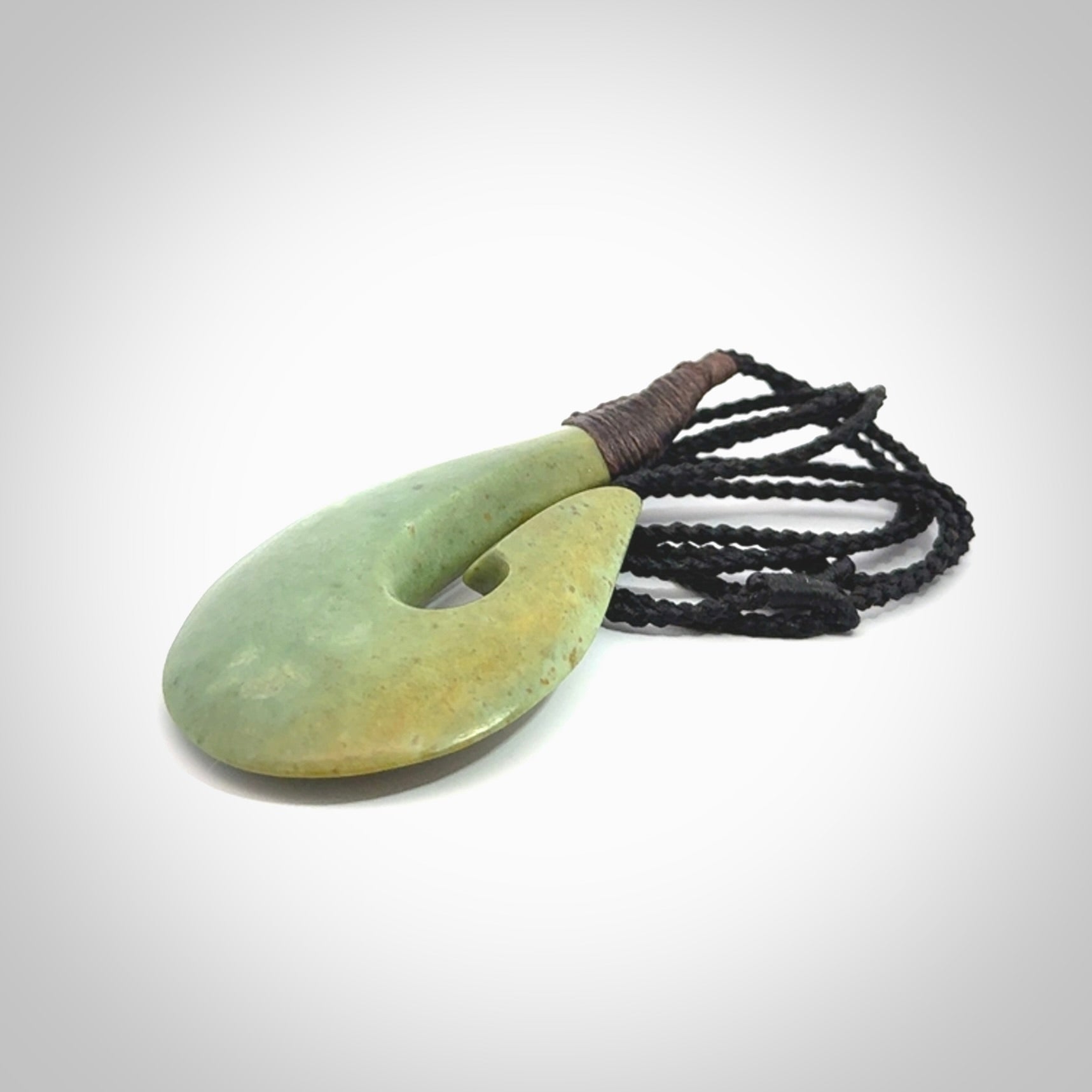 Hand carved New Zealand flower jade hook, matau pendant.