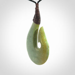 Hand carved New Zealand flower jade hook, matau pendant.