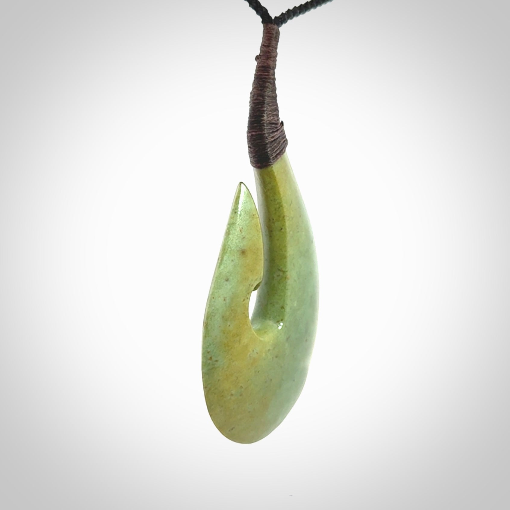 Hand carved New Zealand flower jade hook, matau pendant.