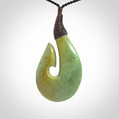 Hand carved New Zealand flower jade hook, matau pendant.