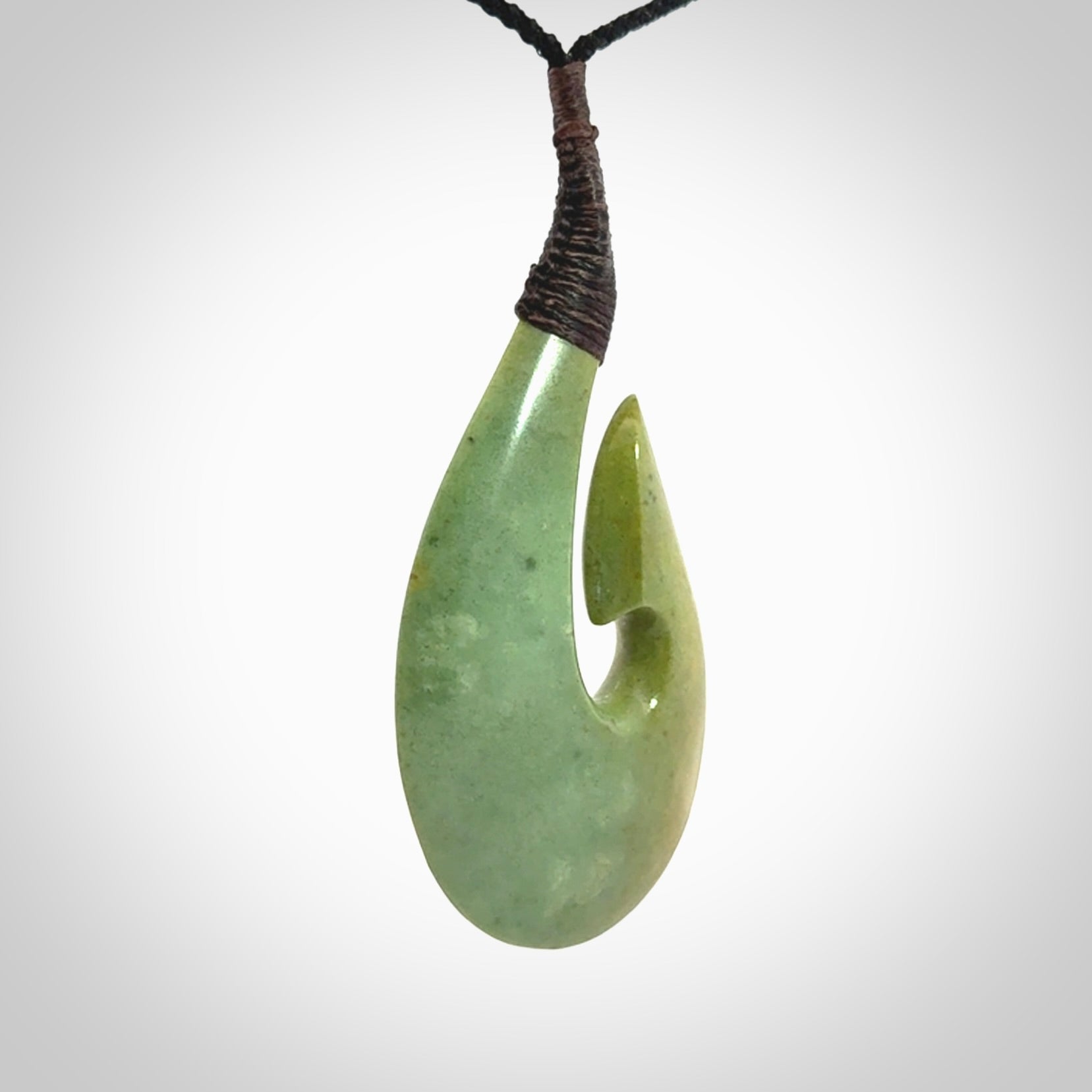 Hand carved New Zealand flower jade hook, matau pendant.