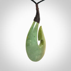Hand carved New Zealand flower jade hook, matau pendant.