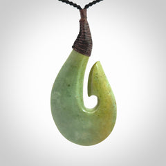 Hand carved New Zealand flower jade hook, matau pendant.